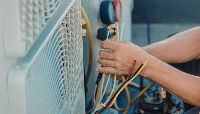 HVAC Tech doing a repair on an HVAC unit outside