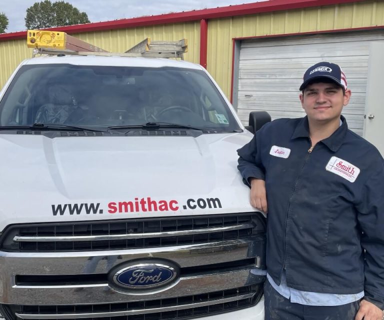 Technician Smiling Leaning On Truck